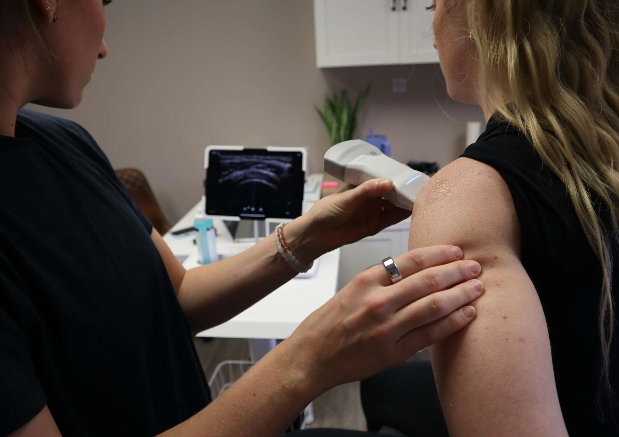 Sonographer conducting a musculoskeletal ultrasound Sonographer conducting a musculoskeletal ultrasound