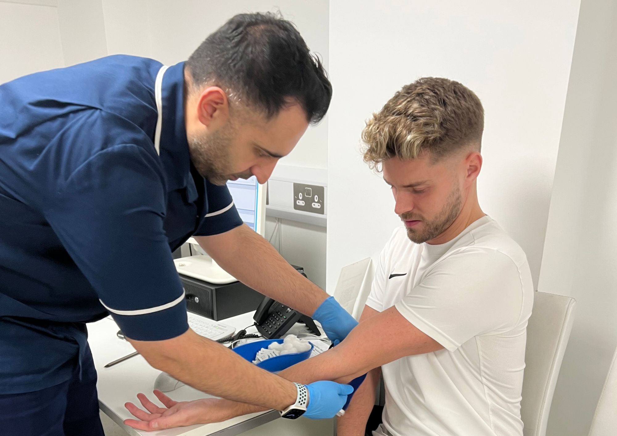 Nurse giving a man a blood test