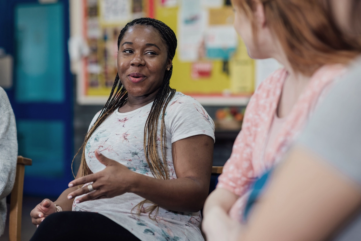 Ladies Discussing Housing Matters At A Public Event
