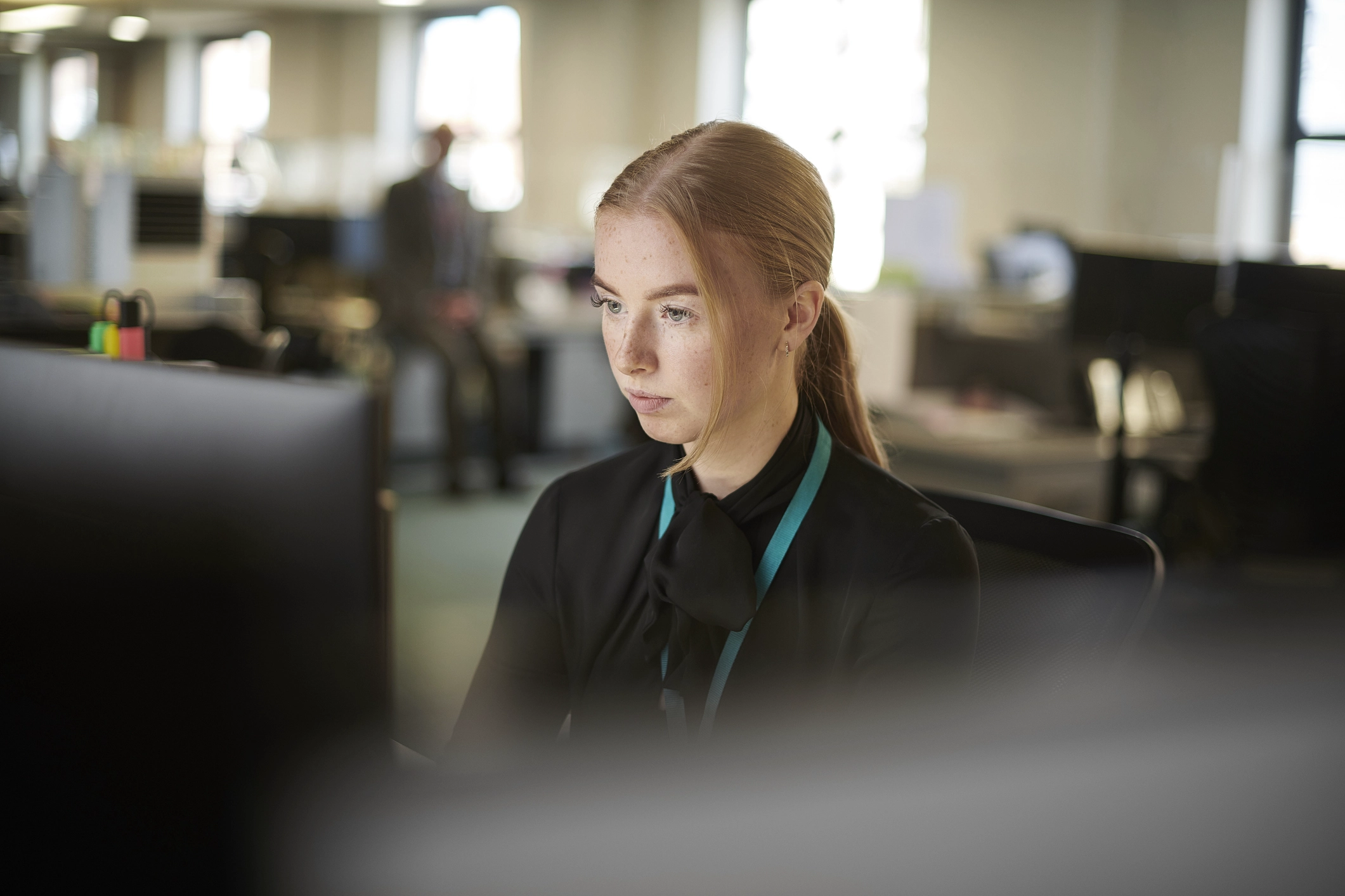 Woman Working At A Laptop Computer In A Office Dealing With A Complex Issue