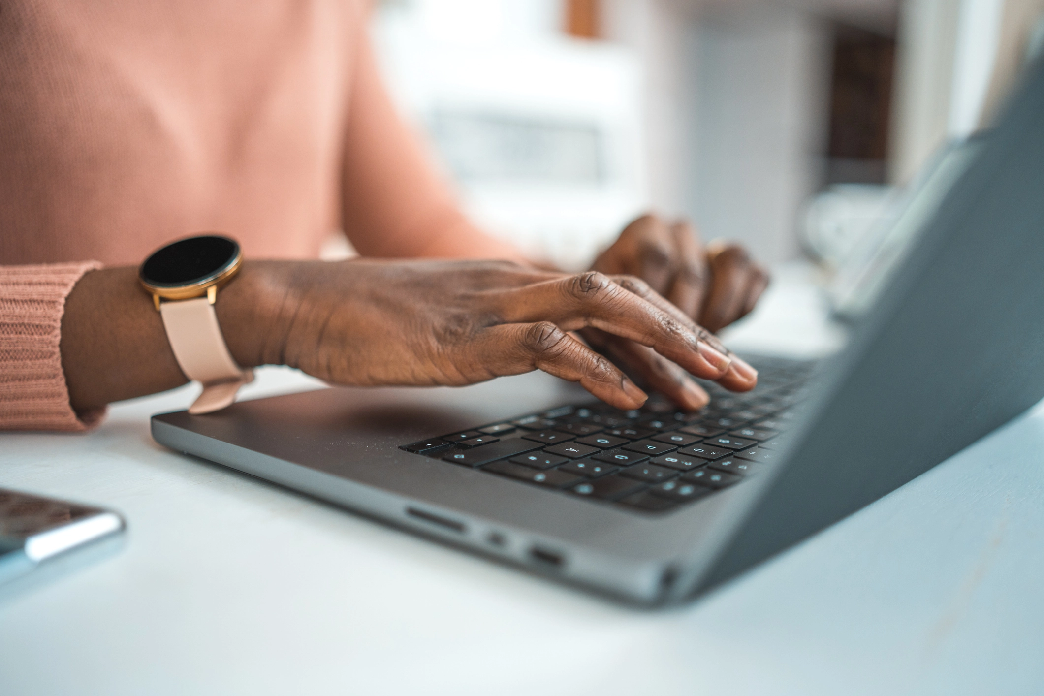 A Woman Using Her Laptop Computer To Log Onto The Customer Portal To Pay Her Bill