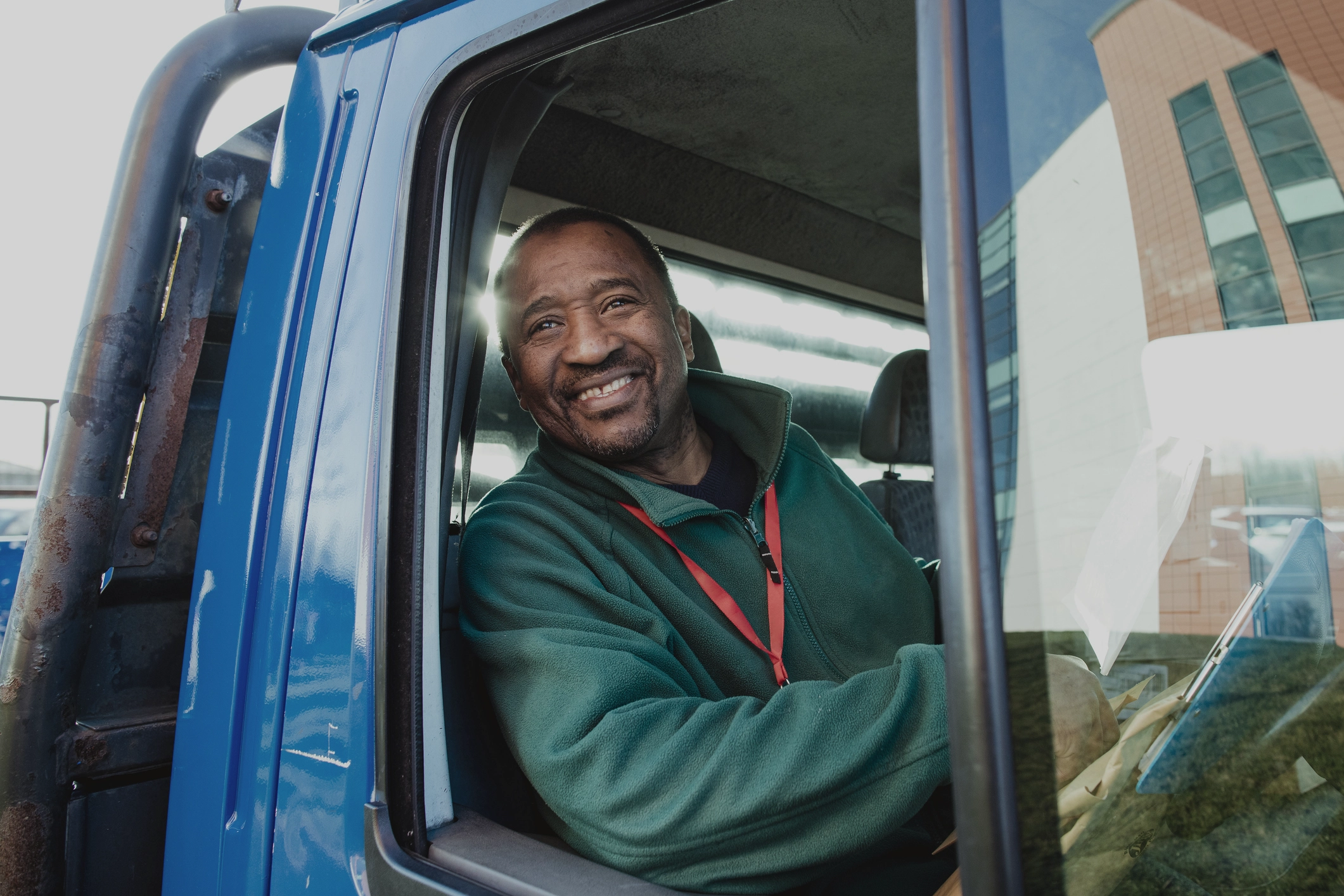 Happy And Smiling Man In A Van Looking Out A Wound Down Window With His Elbow On The Van Door