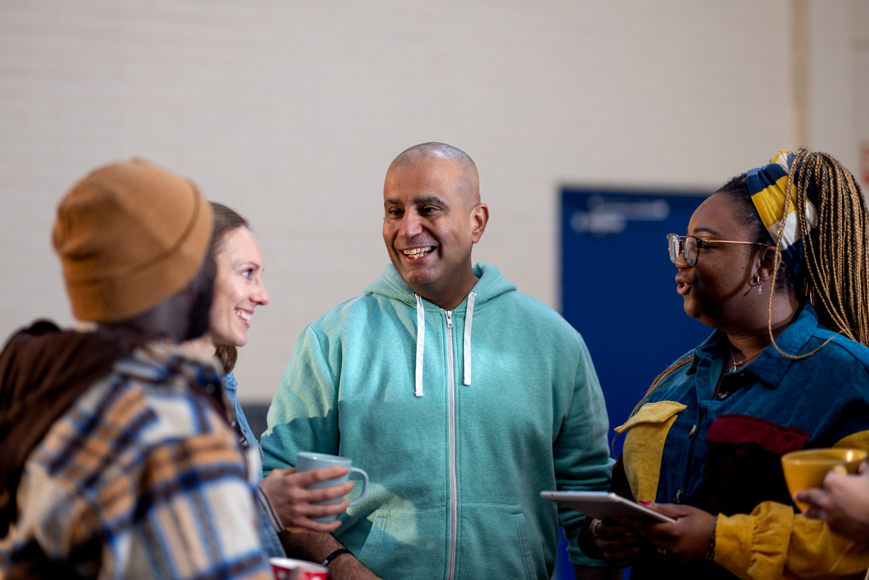 2 Men And 2 Women Talking In A Group