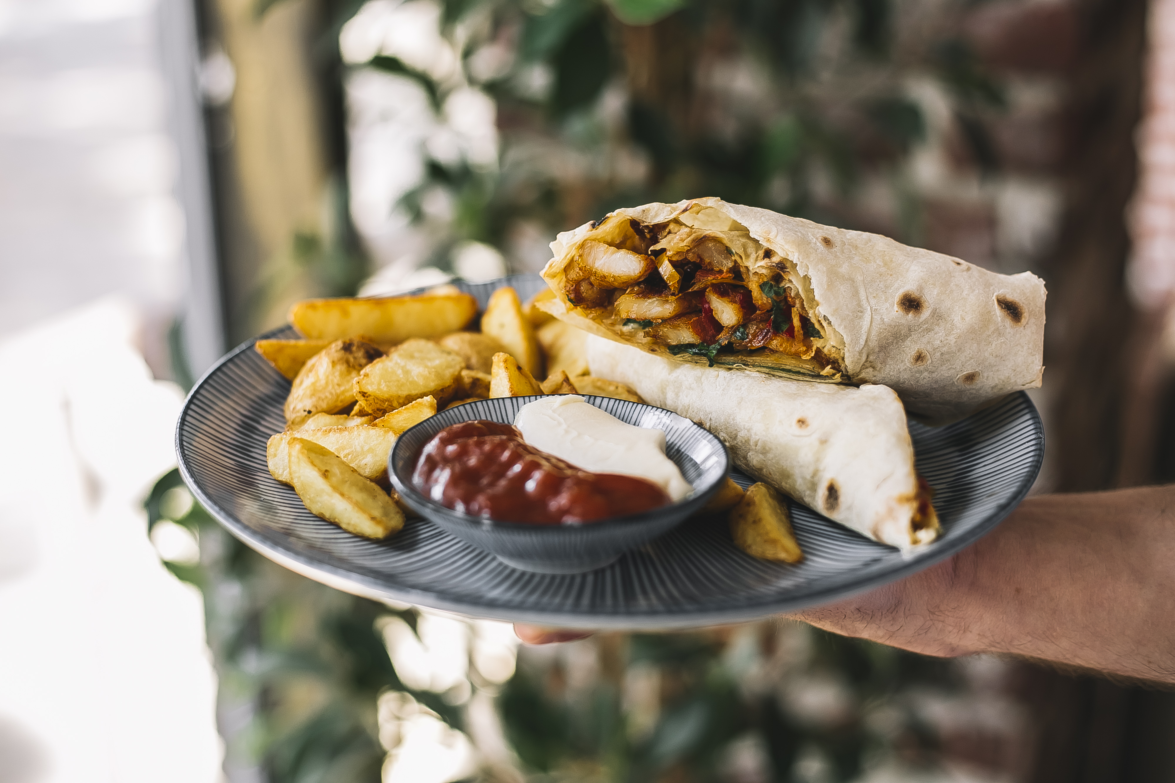 Man Holding Chicken Burrito Served With Fries Mayonnaise Ketchup