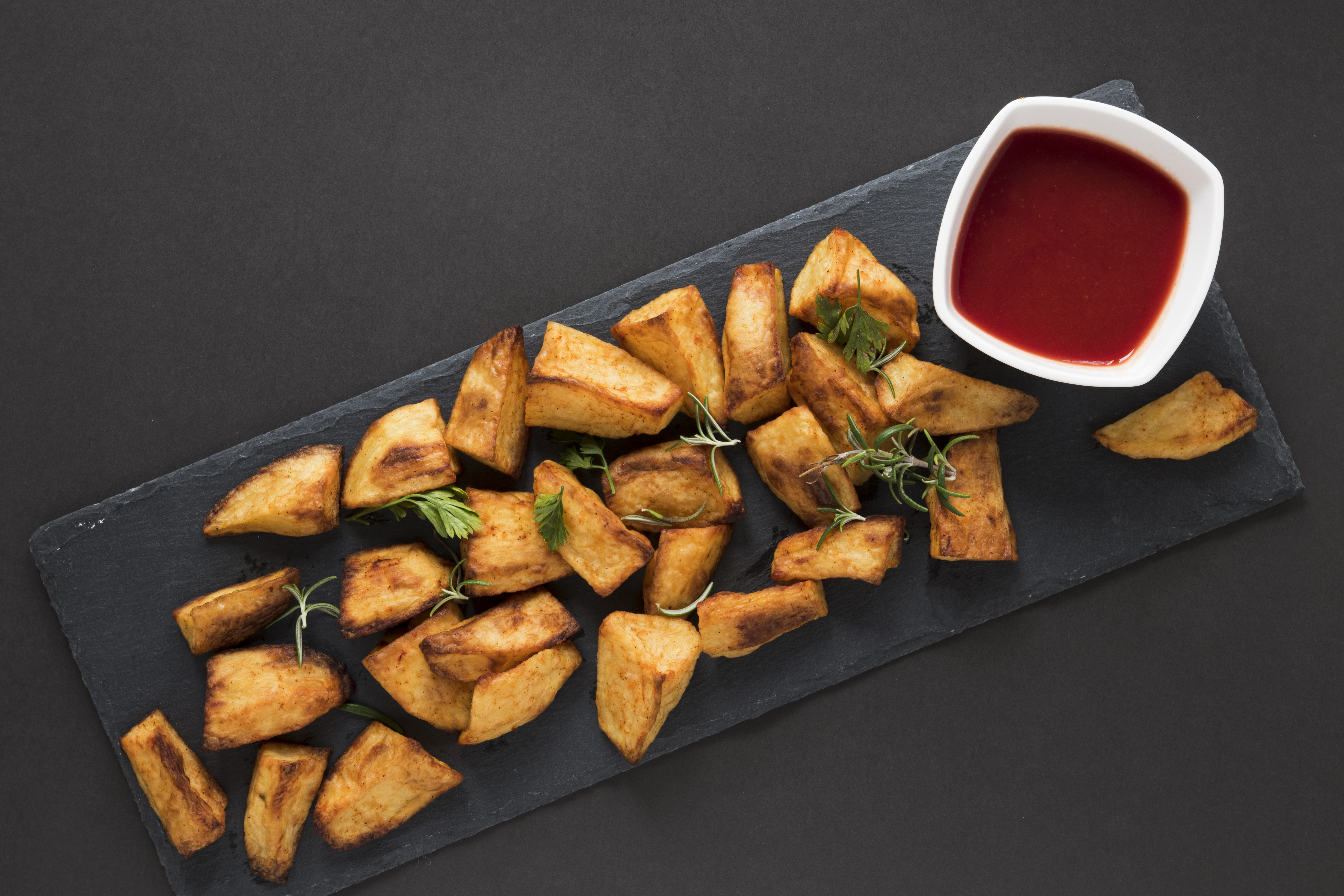 Top View Cooked Potatoes With Ketchup Bowl