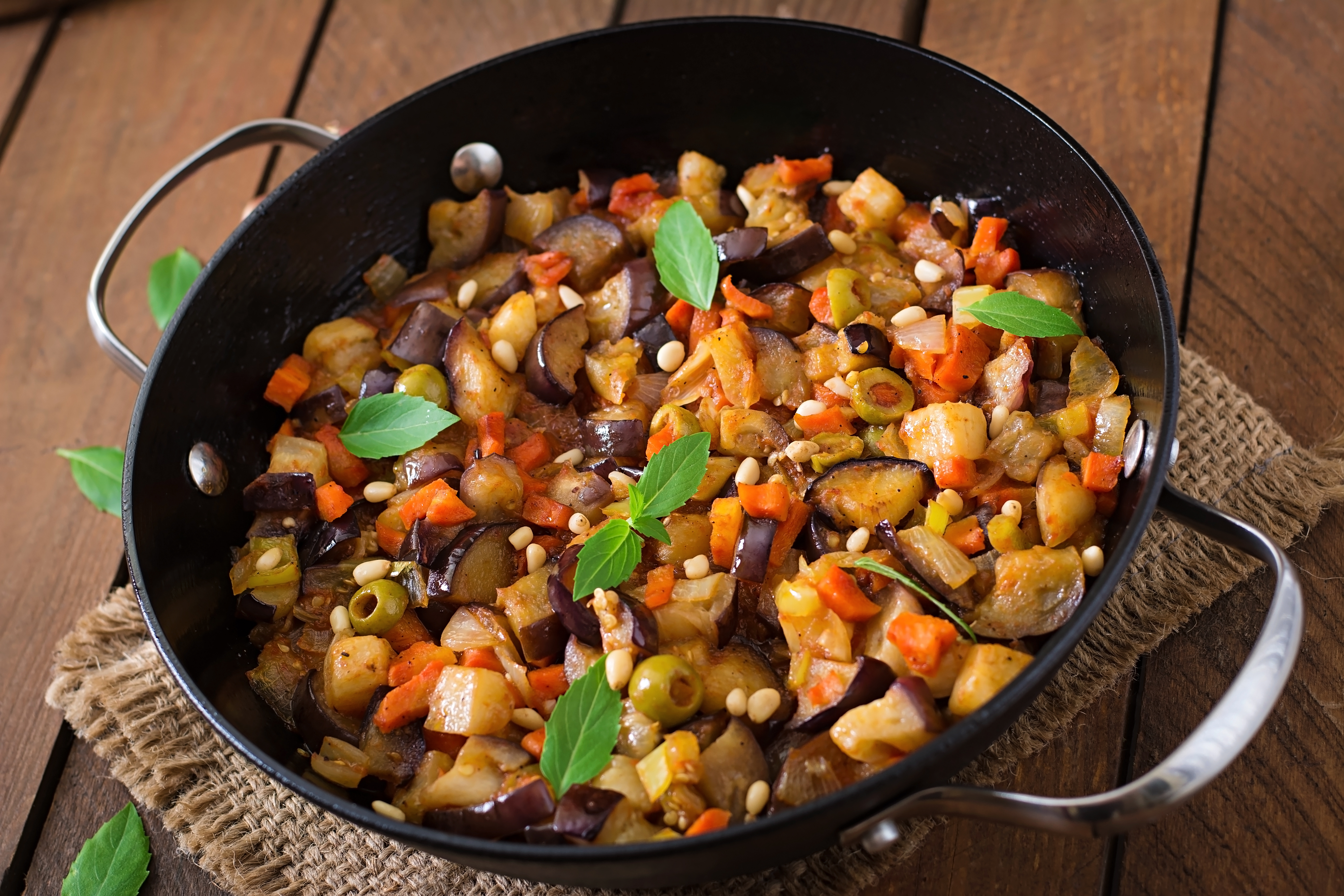 Italian Caponata With Frying Pan Wooden Table