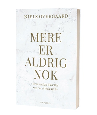 'Mere er aldrig nok' af Niels Overgaard