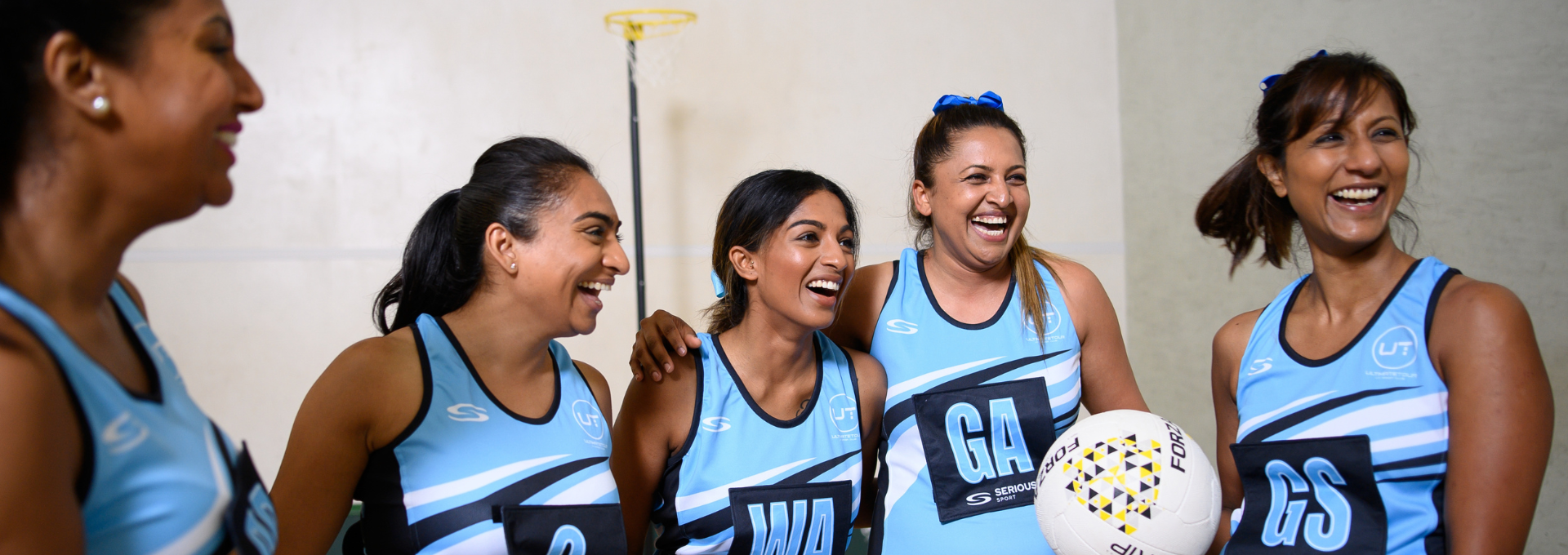 Group of netballers in the sky blue Serious Sport netball dress