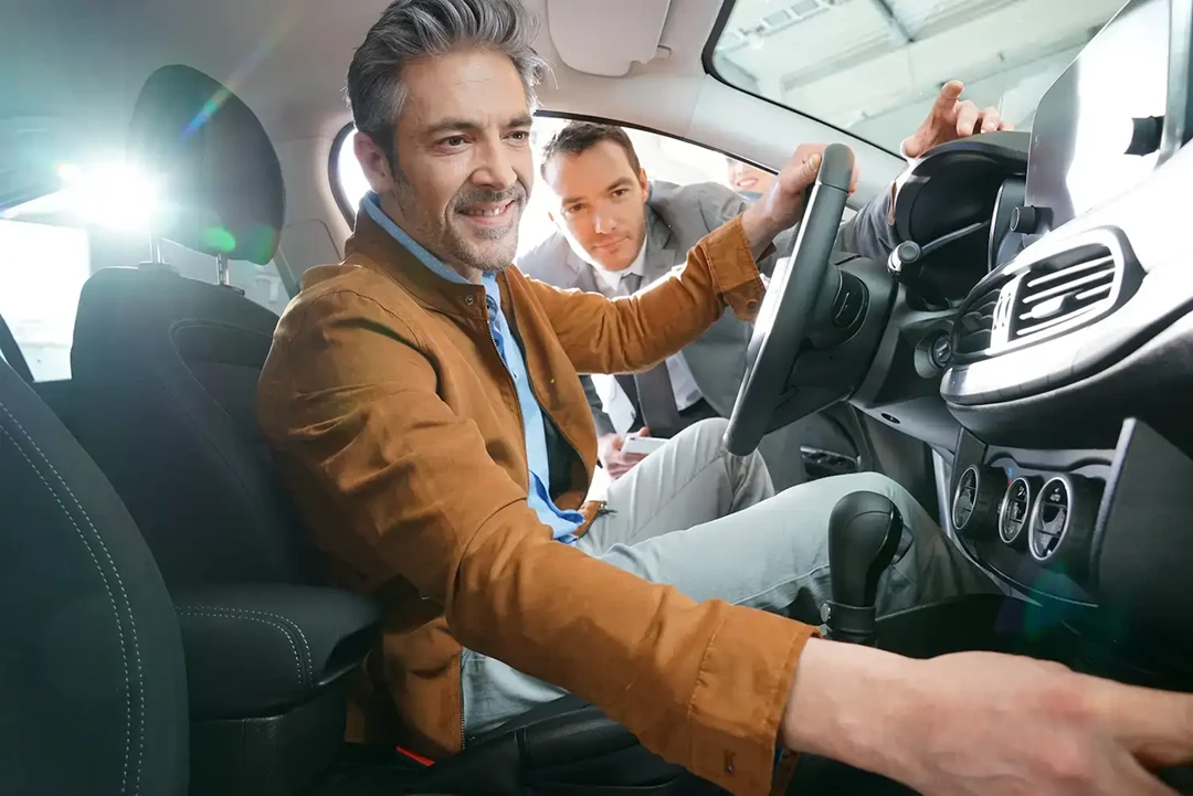 Man checking out the interior of a car