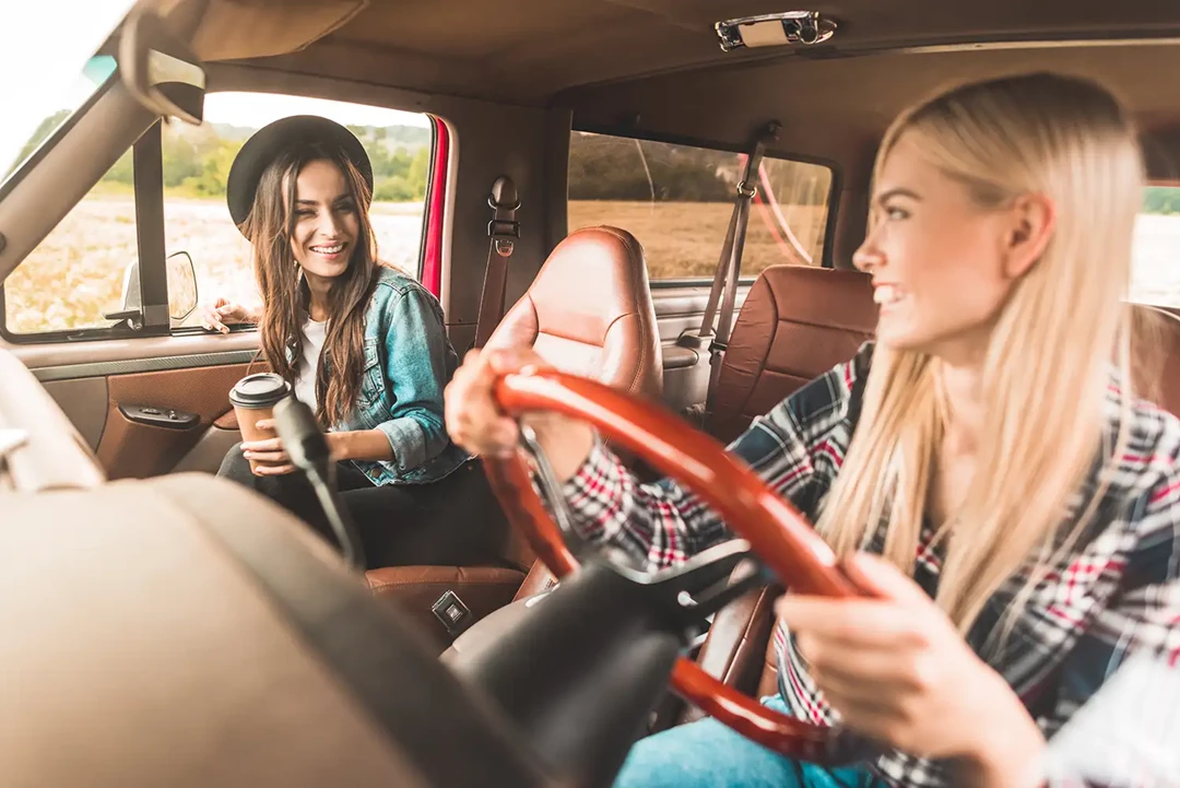 Two young women driving in their car