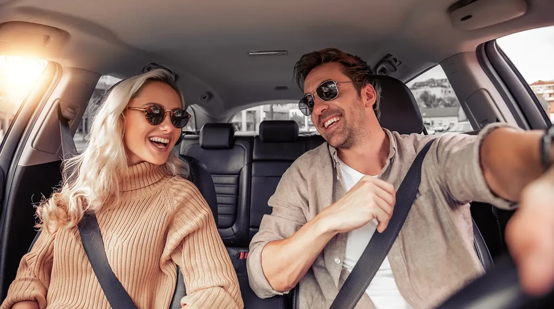 Interior of a car with a happy young couple