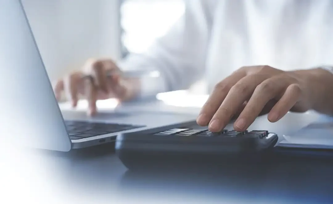 Man with laptop and calculator