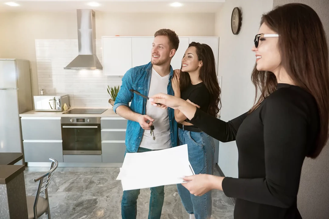 Real estate agent showing renters around a property