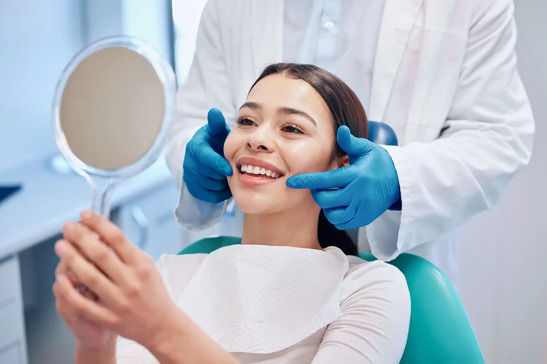 Woman in dentist's chair after treatment