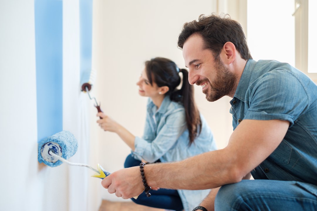 Couple painting the inside of their home