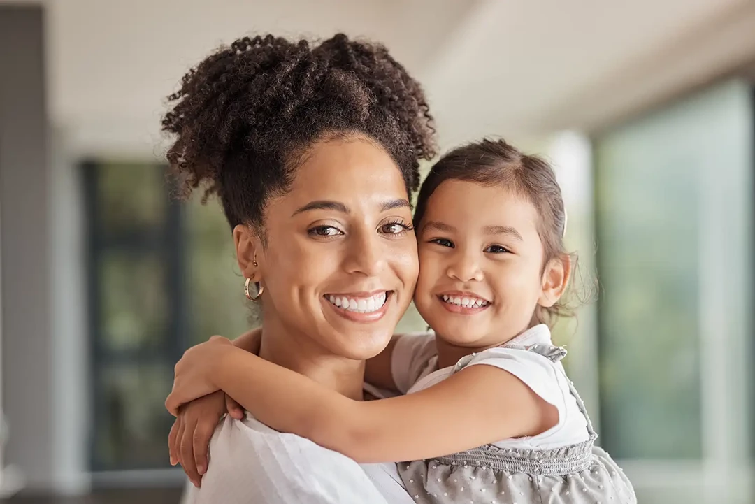 Mother with child in her arms at home