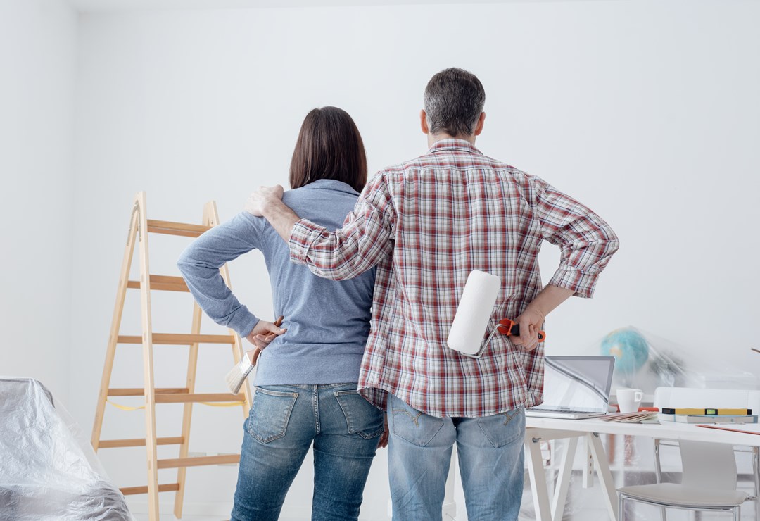 Couple decorating a room