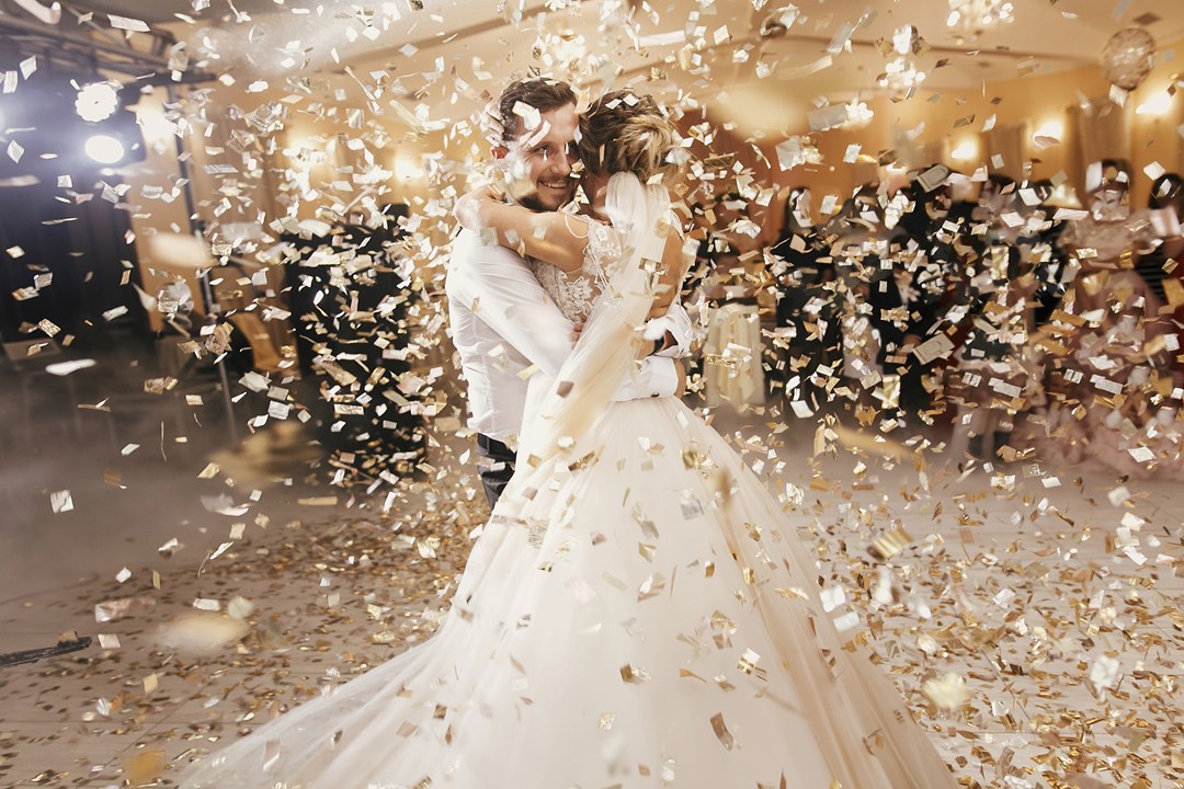 Bride and Groom with confetti at wedding 