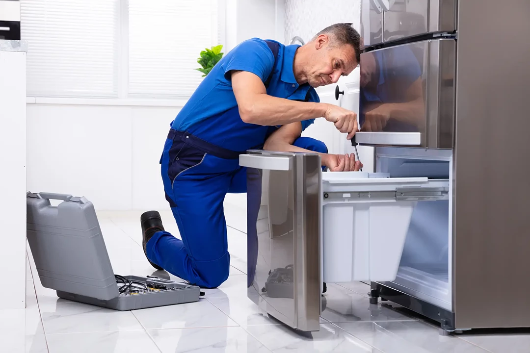 Man repairing a broken fridge