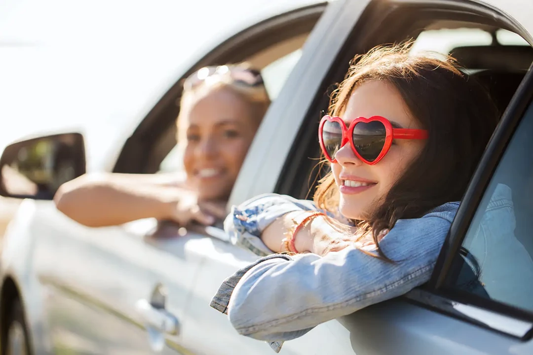 Women leaning out of open car windows