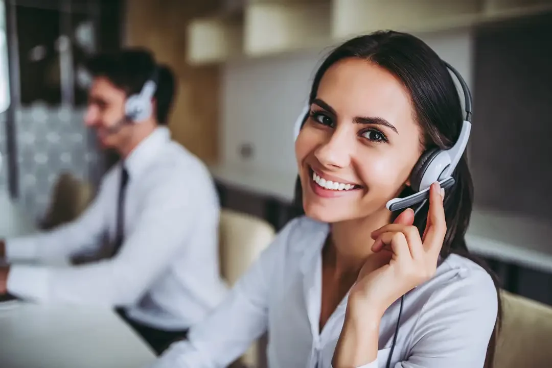 Office with workers using phone call headsets