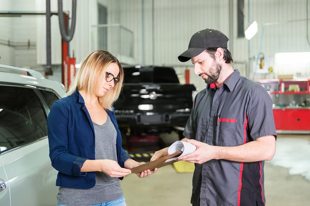 Car workshop with mechanic and customer