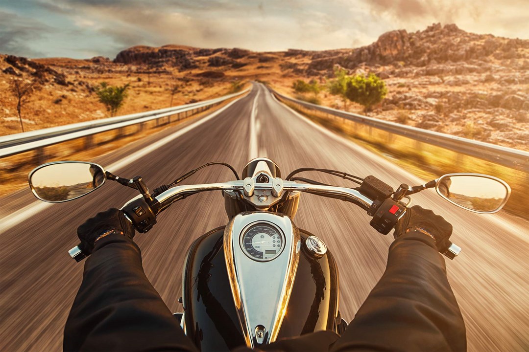 Motorbike on an empty desert road.