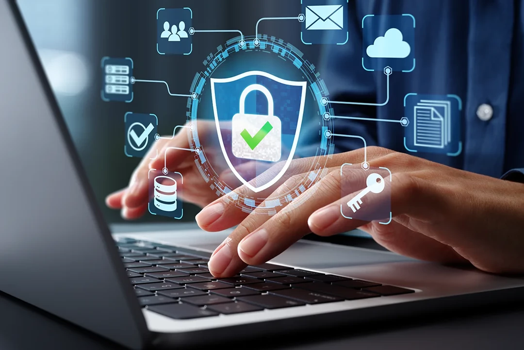 Person typing on their laptop with security icons