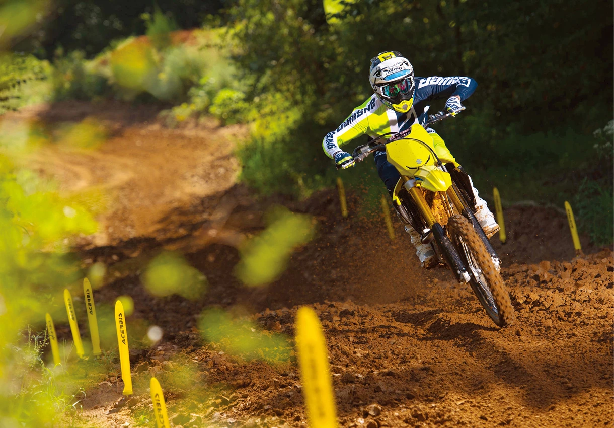 Suzuki RM-Z450 performing a jump on a Motorcross track