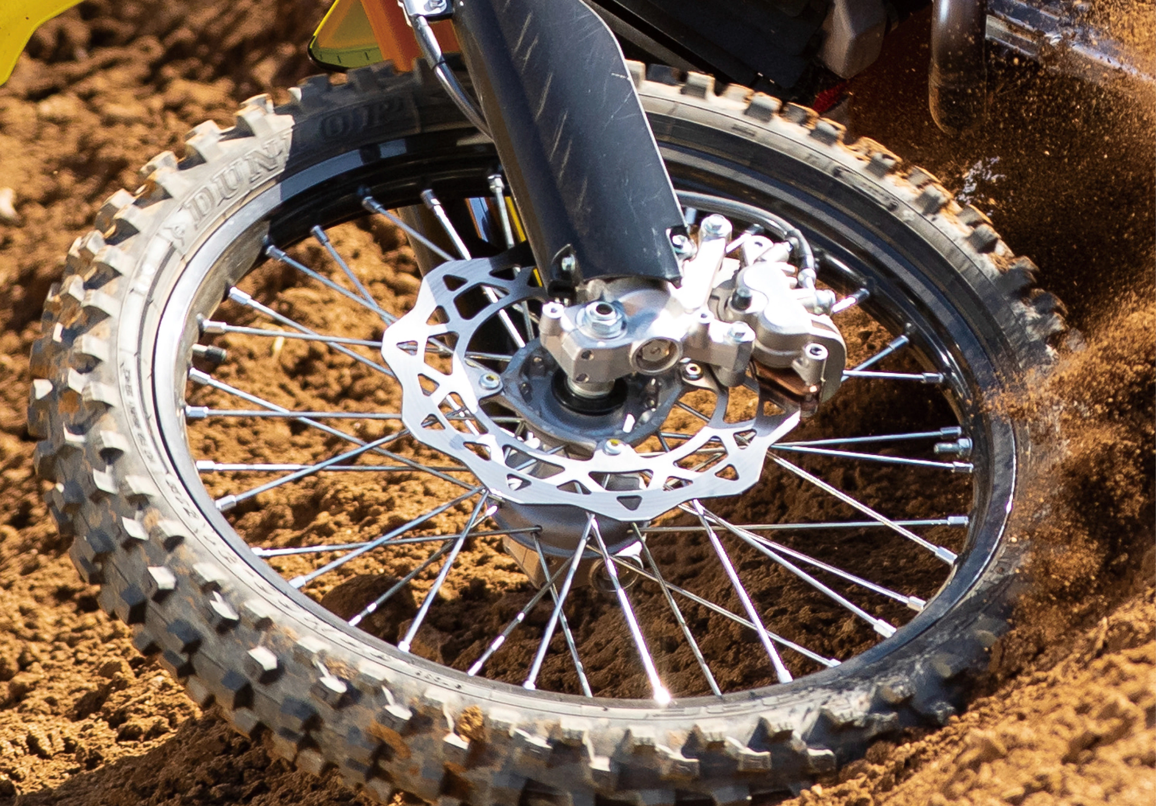 Suzuki RM-Z250 front wheel and brakes close up on a Motocoss track