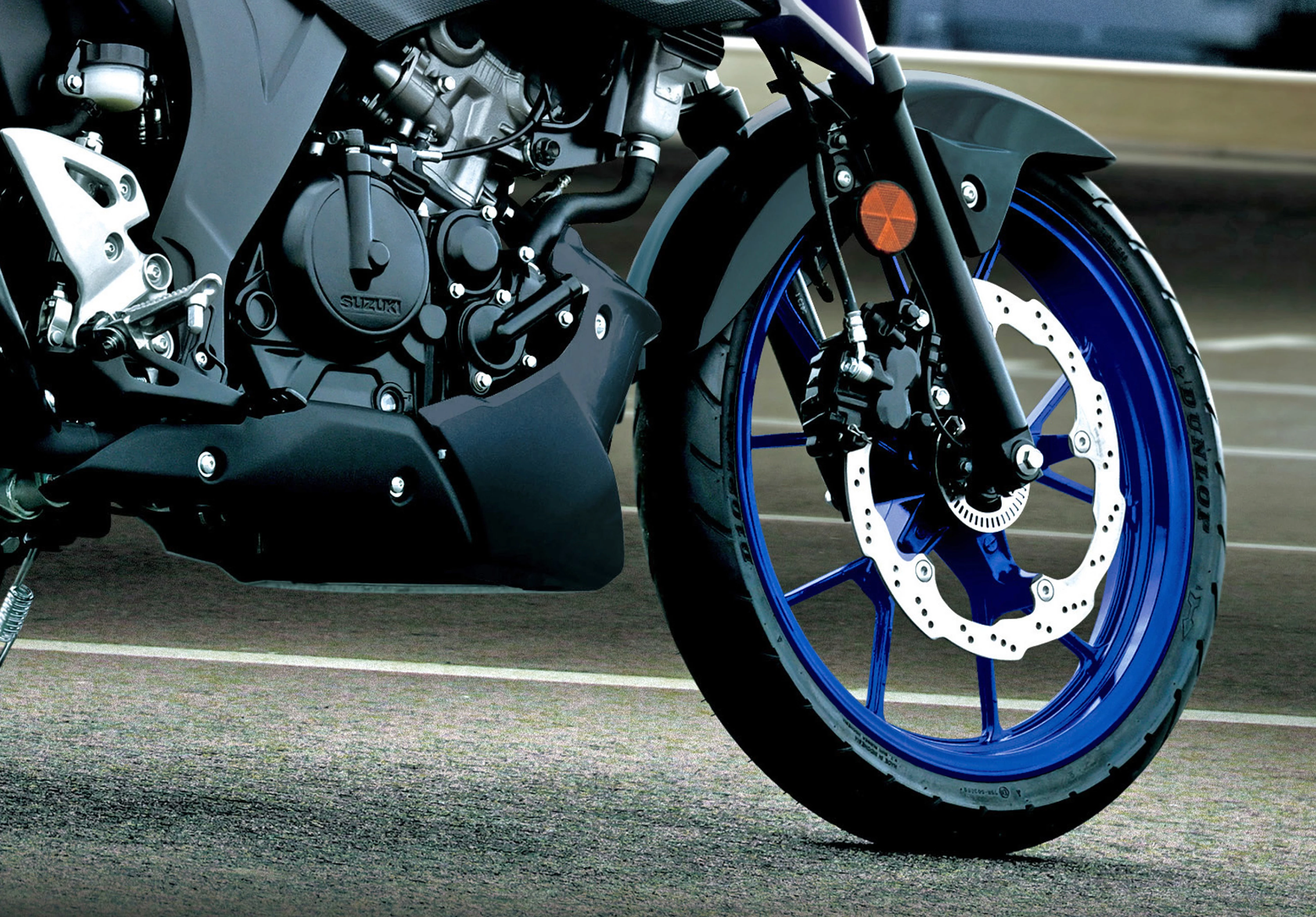 Suzuki GSX-S125 front wheel and engine close up.