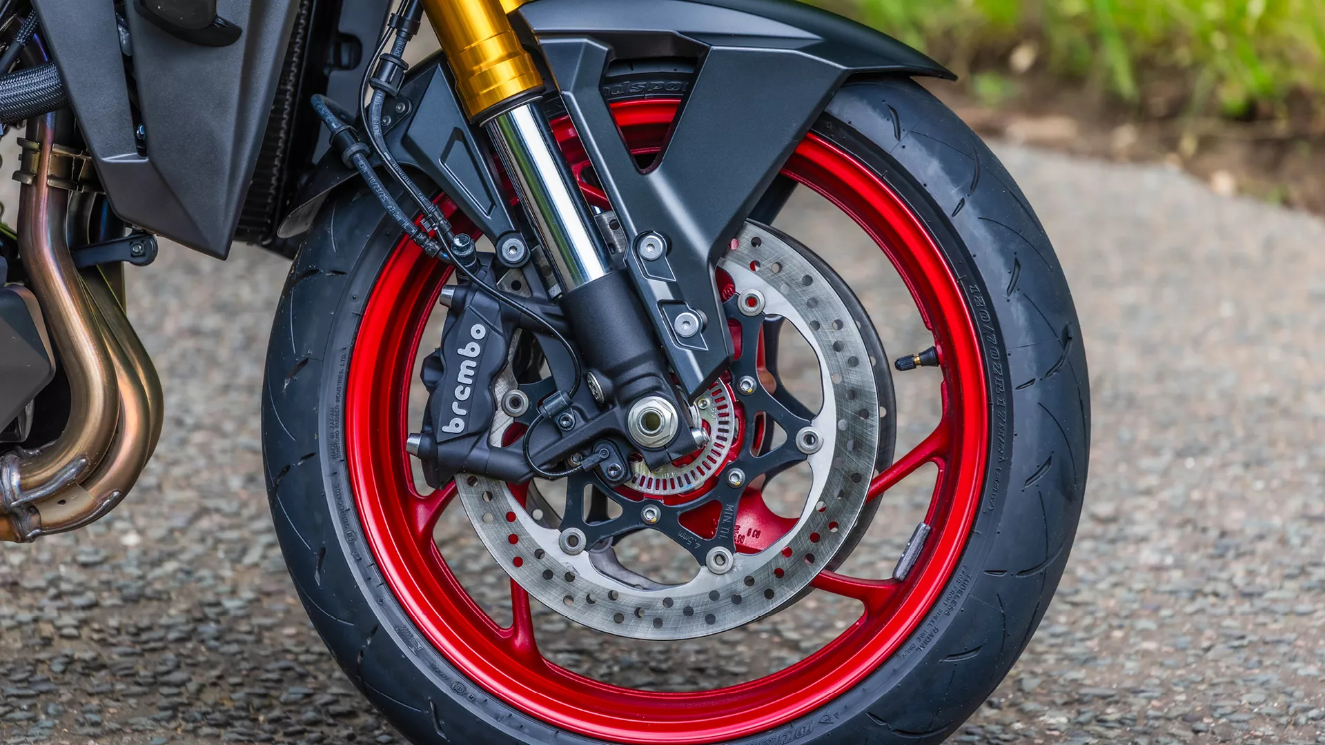Suzuki GSX-S1000GX+ front wheel and brakes close-up.