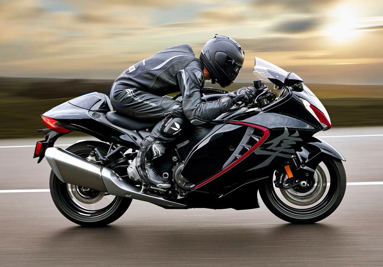 Suzuki Hayabusa left hand side pushing on along a country road.