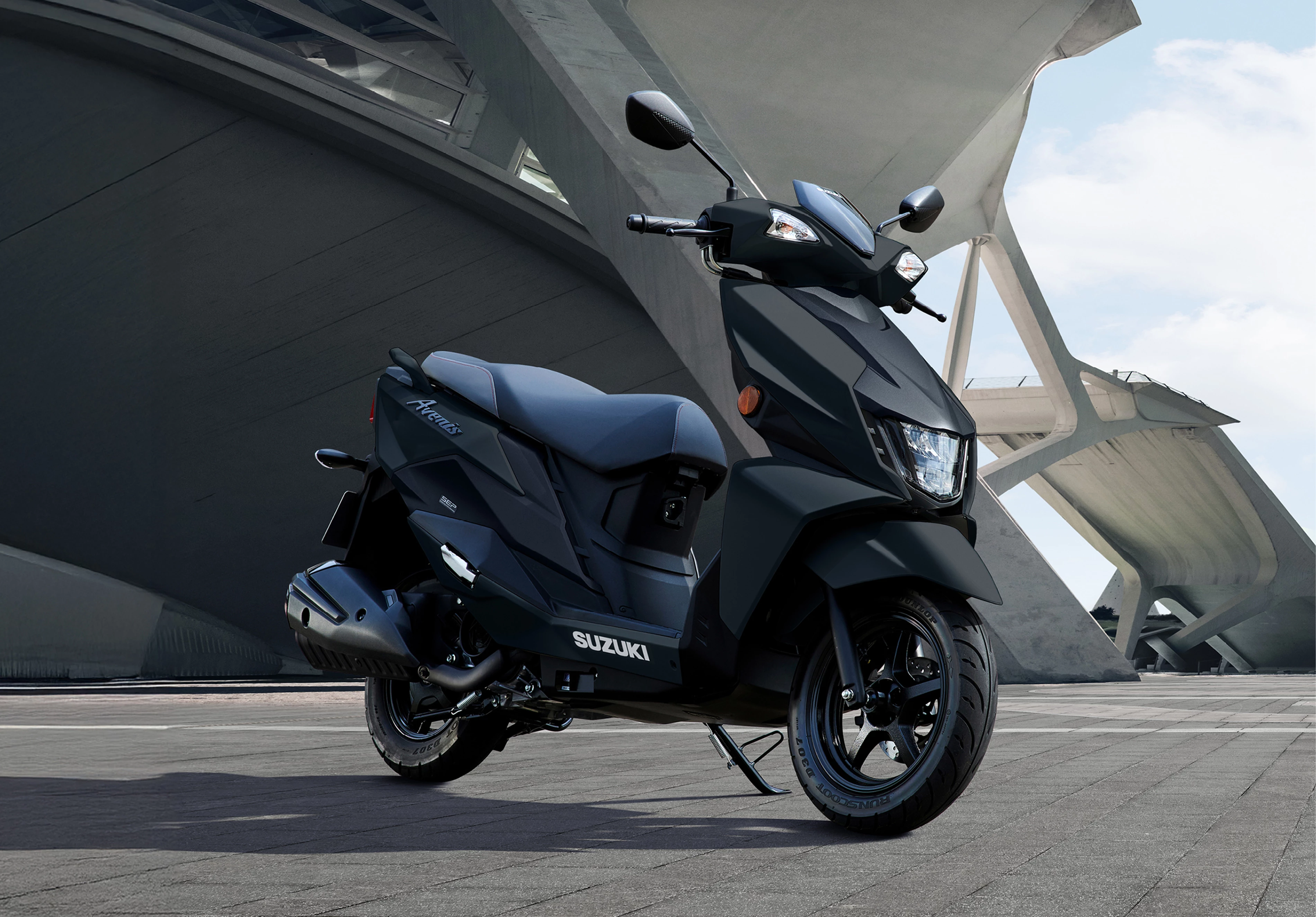 Suzuki Avenis 125 scooter showcased against a backdrop of modern architectural structures, highlighting its sleek and contemporary design.