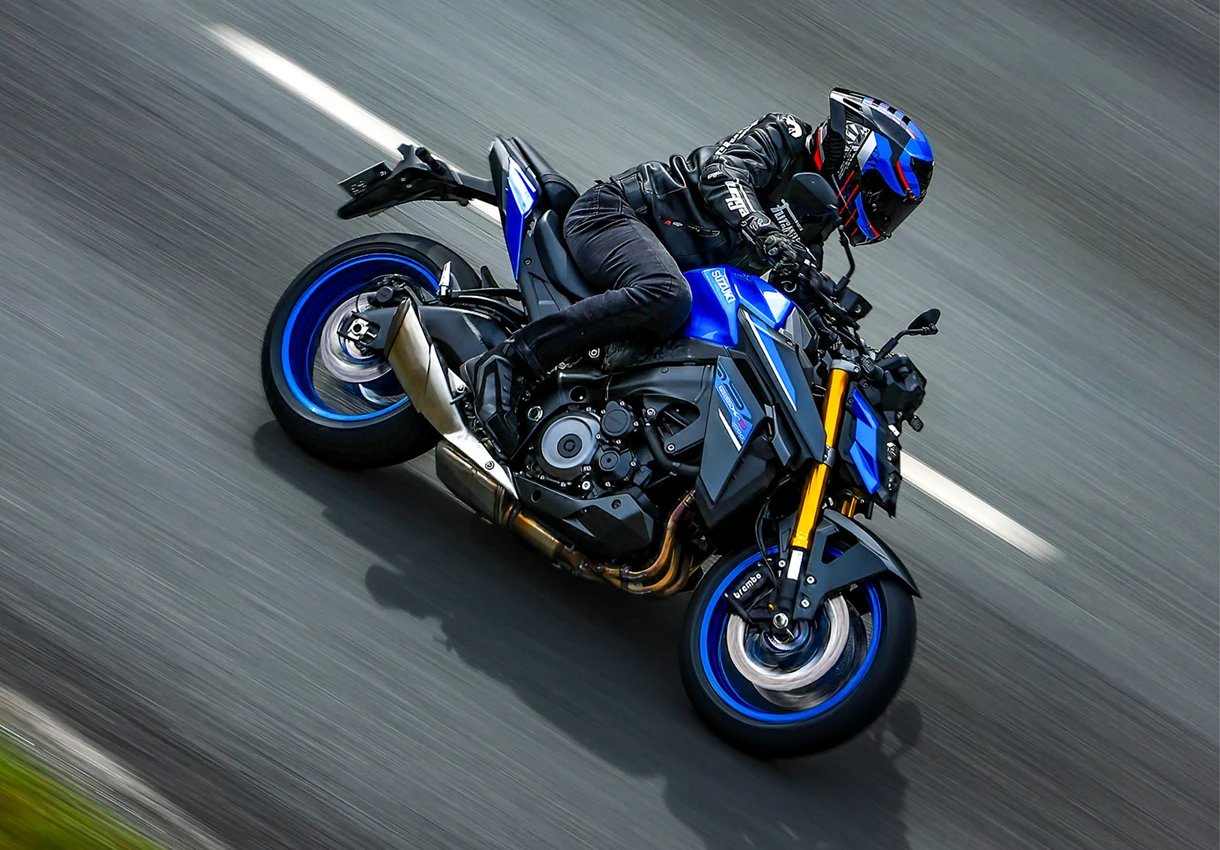 Suzuki GSX-S1000 cruising along a country road.