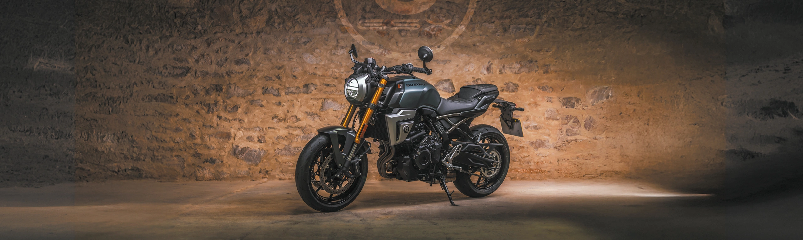 Suzuki GSX-8T green, left hand side on static with a brick wall and the 8 ball GSX logo behind