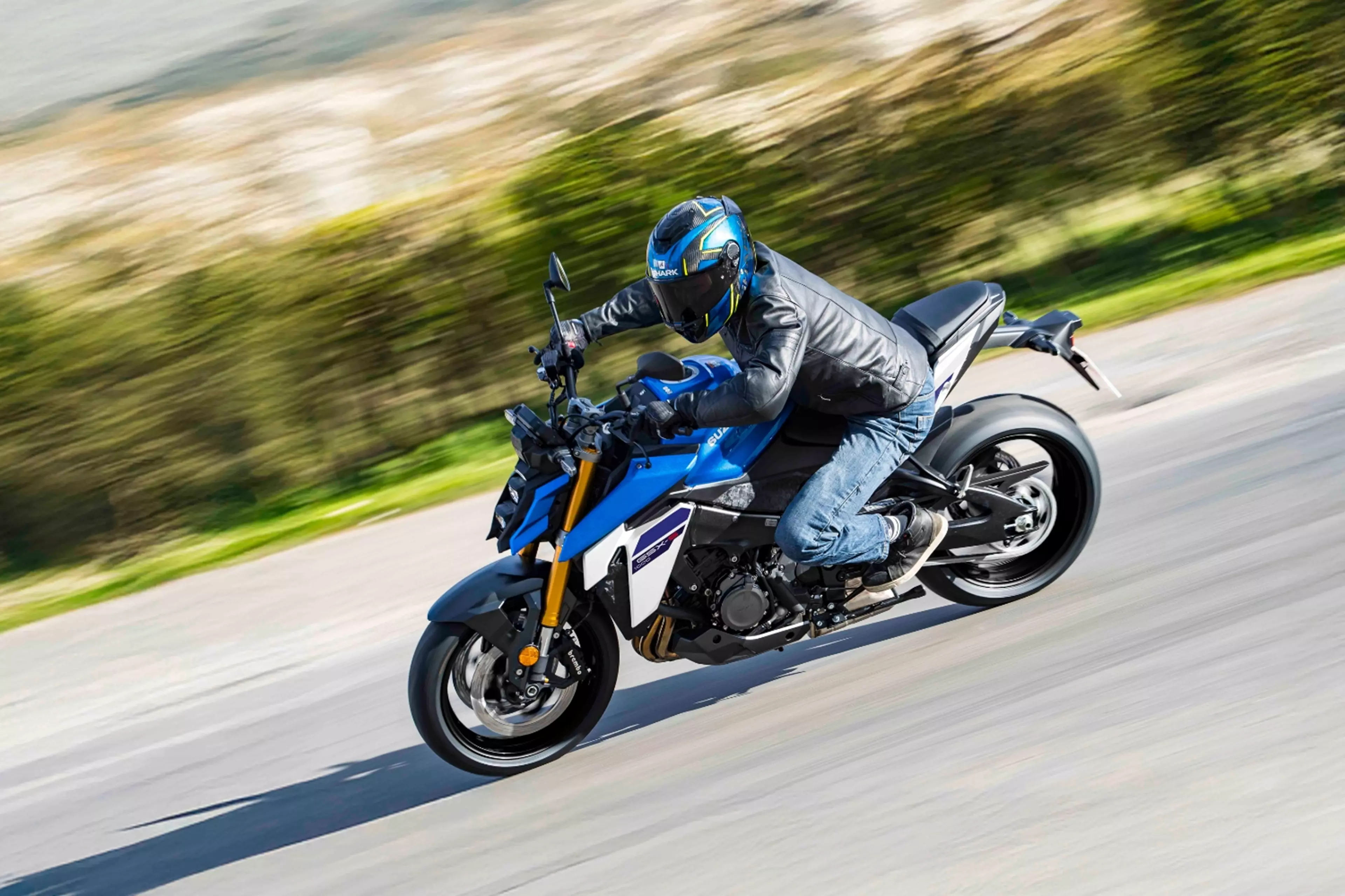 Blue Suzuki GSX-S1000 going around a corner