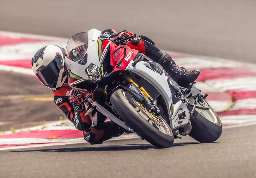 Suzuki GSX-R1000R leant over pushing hard coming out of a corner on track