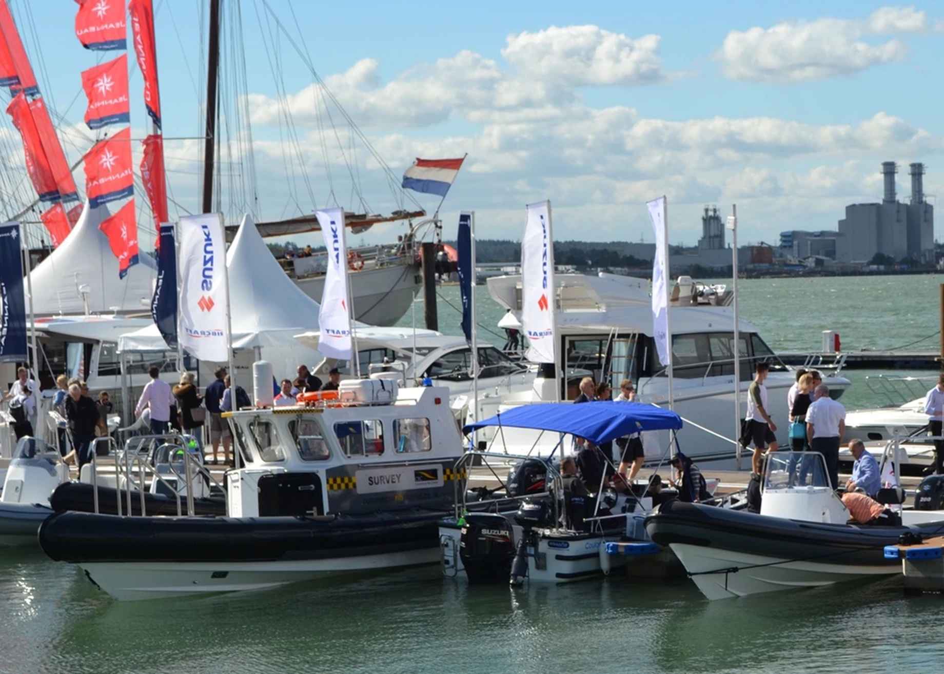 Suzuki-powered boats moored at a boat show.