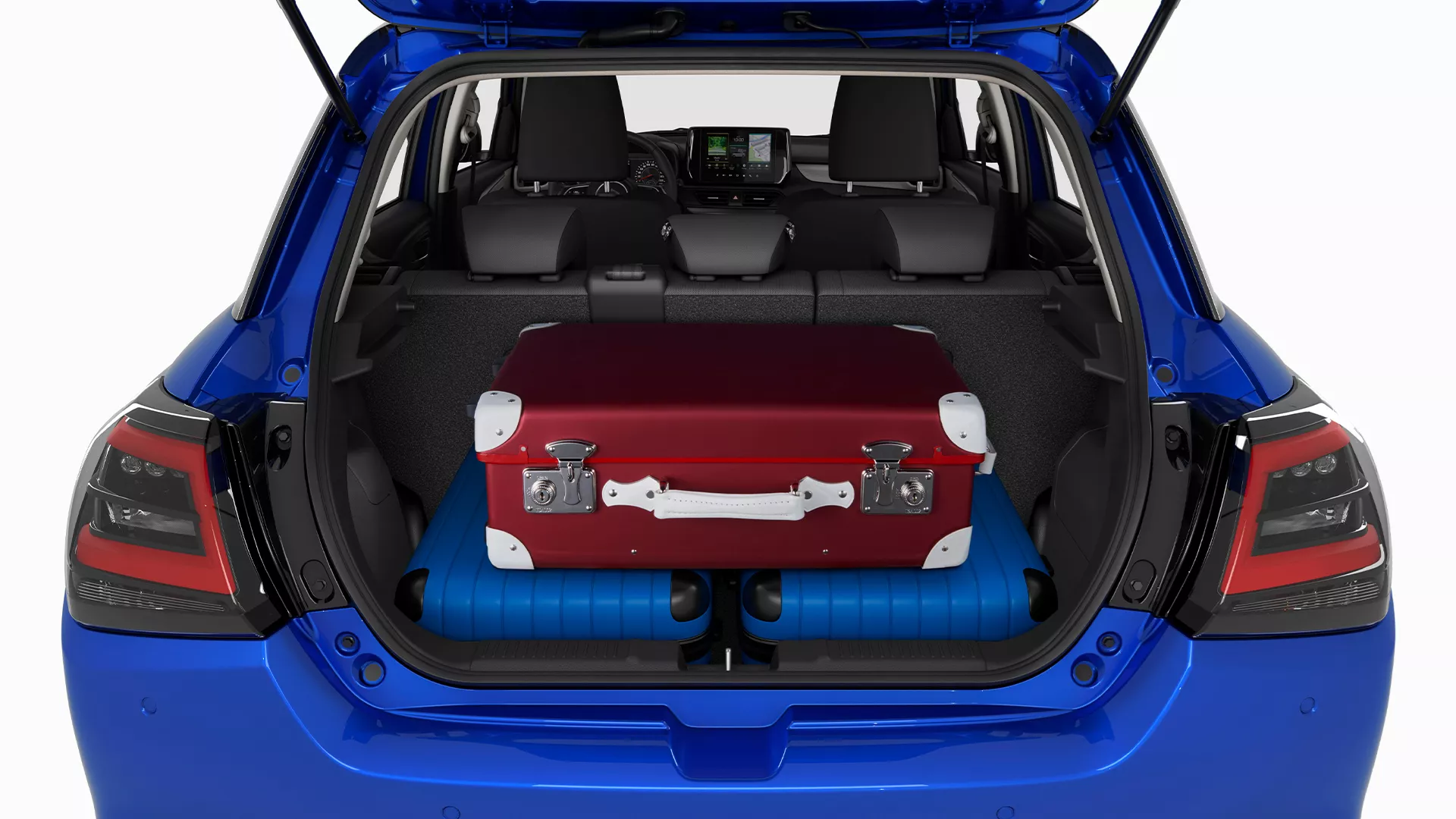 Rear view of the Suzuki Swift boot loaded with suitcases, highlighting available luggage space and split-folding rear seats