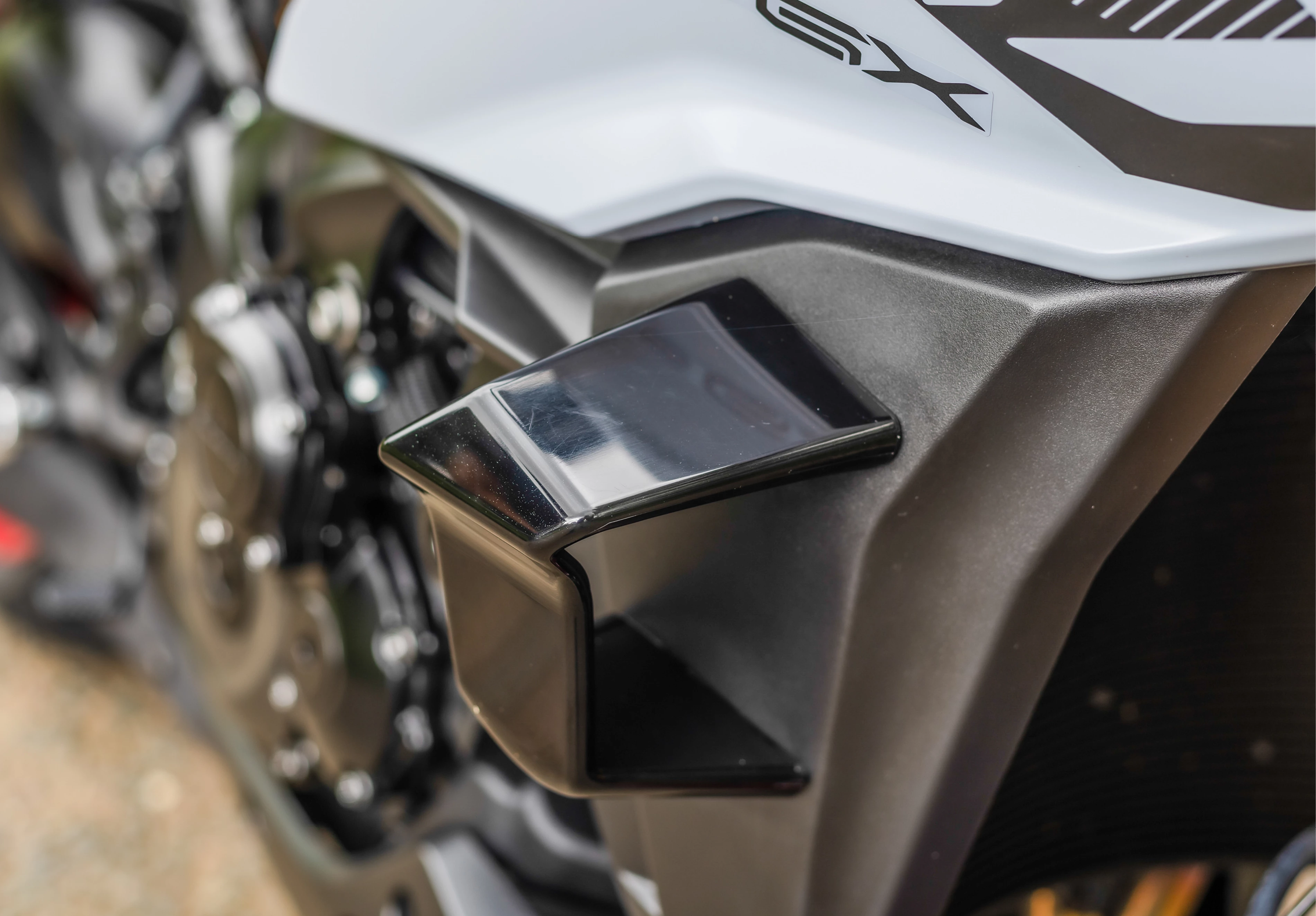 Suzuki GSX-S1000GX+ close-up of the winglet on the front fairing. 