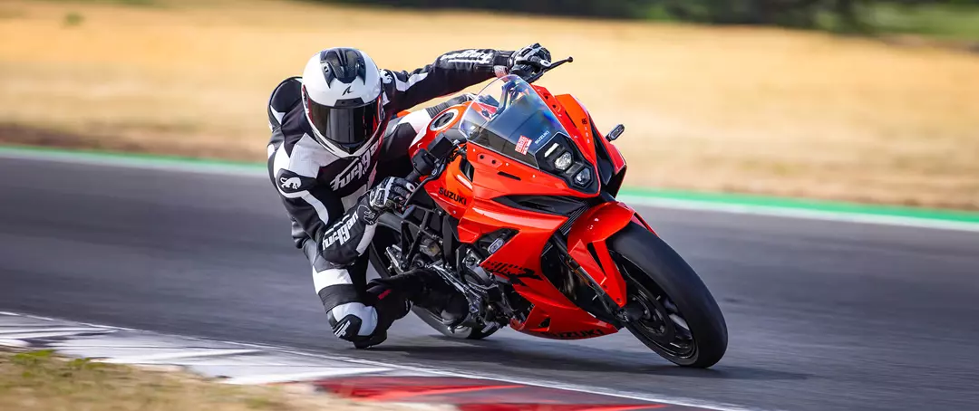 Suzuki GSX-8R leaning heavily into a corner whilst out on track. 