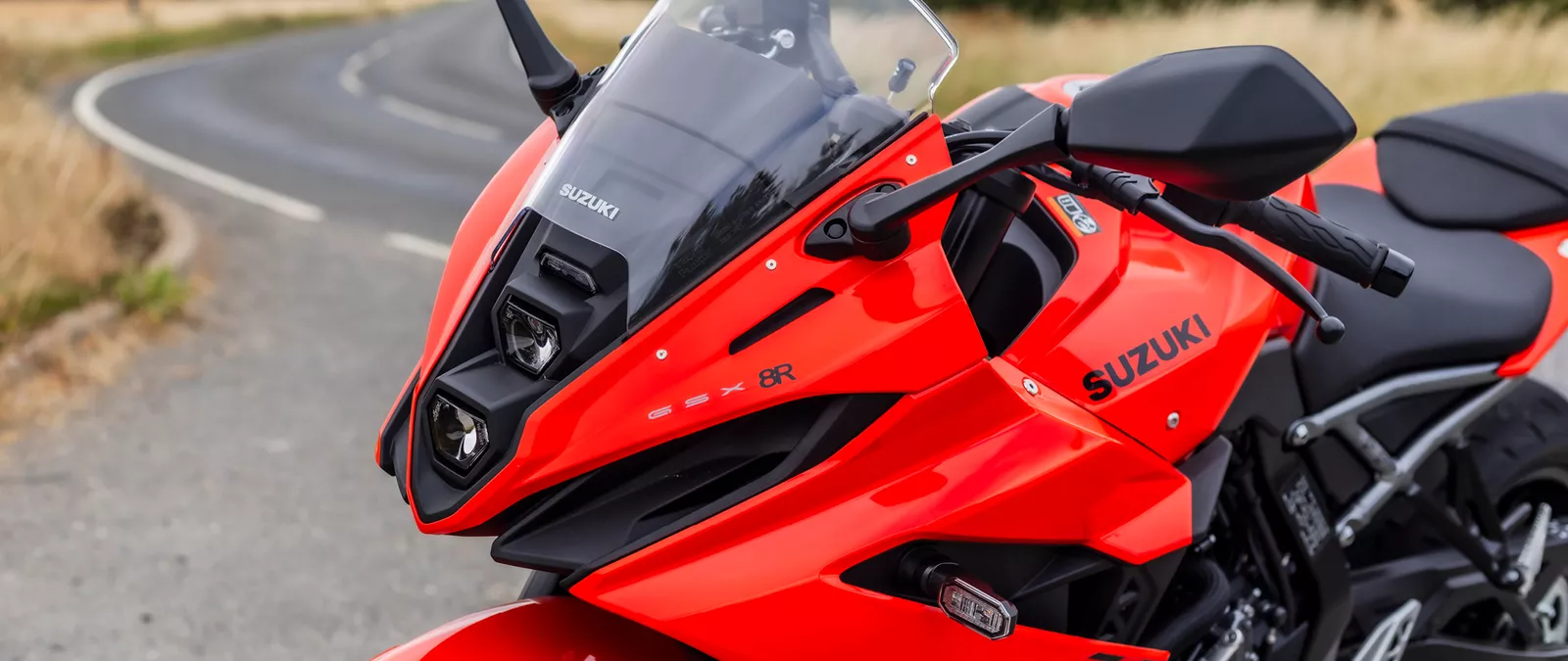 Suzuki GSX-8R orange left hand side front three quarters showcasing LED headlights
