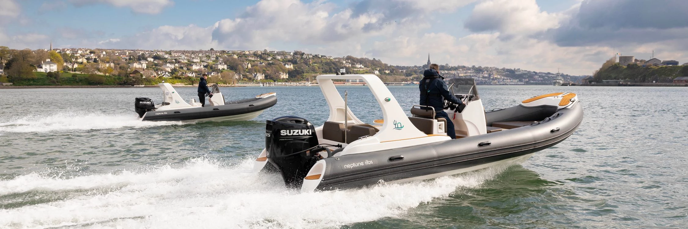 Two Neptune RIBs driving alongside each other, powered by Suzuki outboards