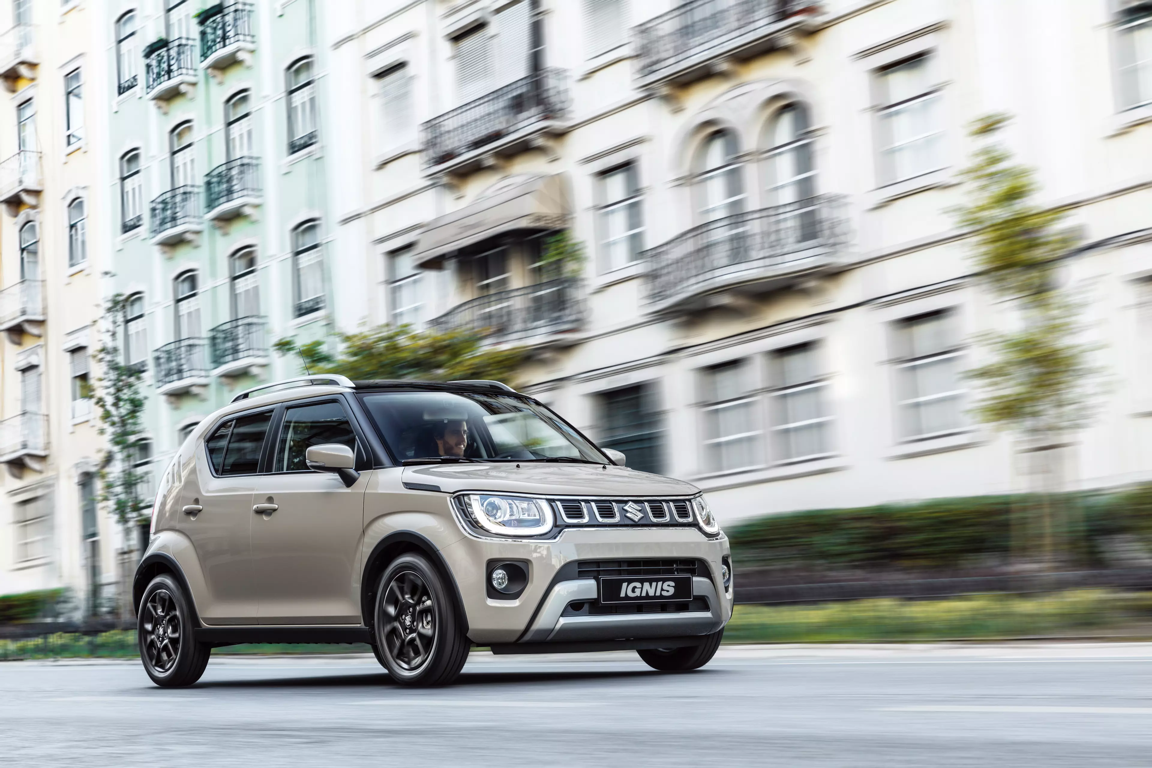 Ivory Suzuki Ignis driving on a road