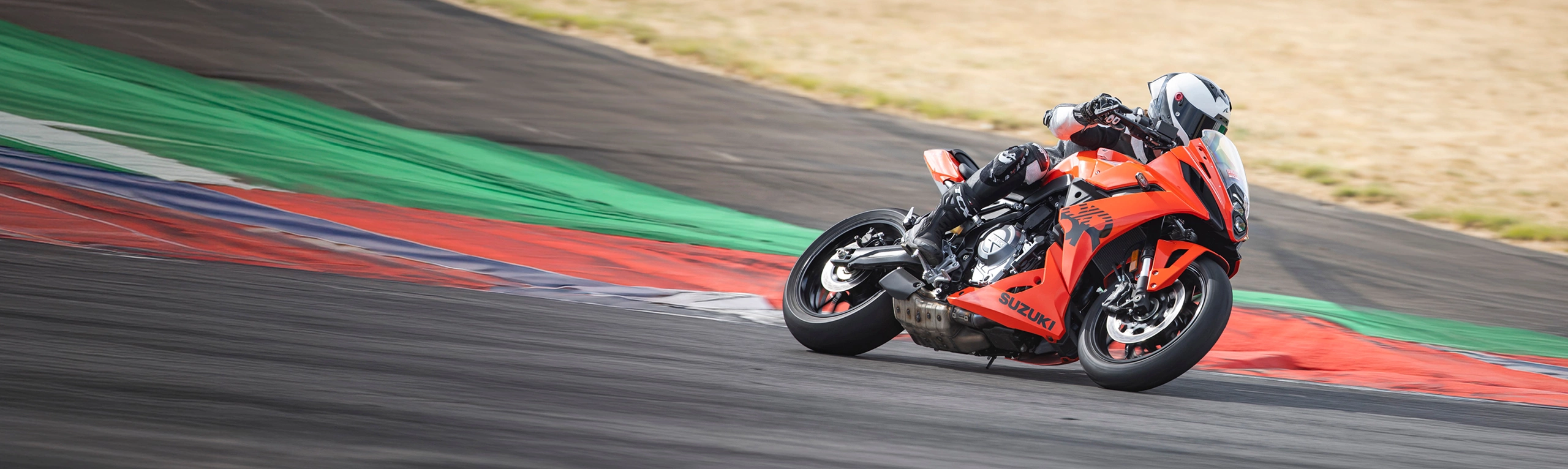 Suzuki GSX-8R orange leaning into a corner on track