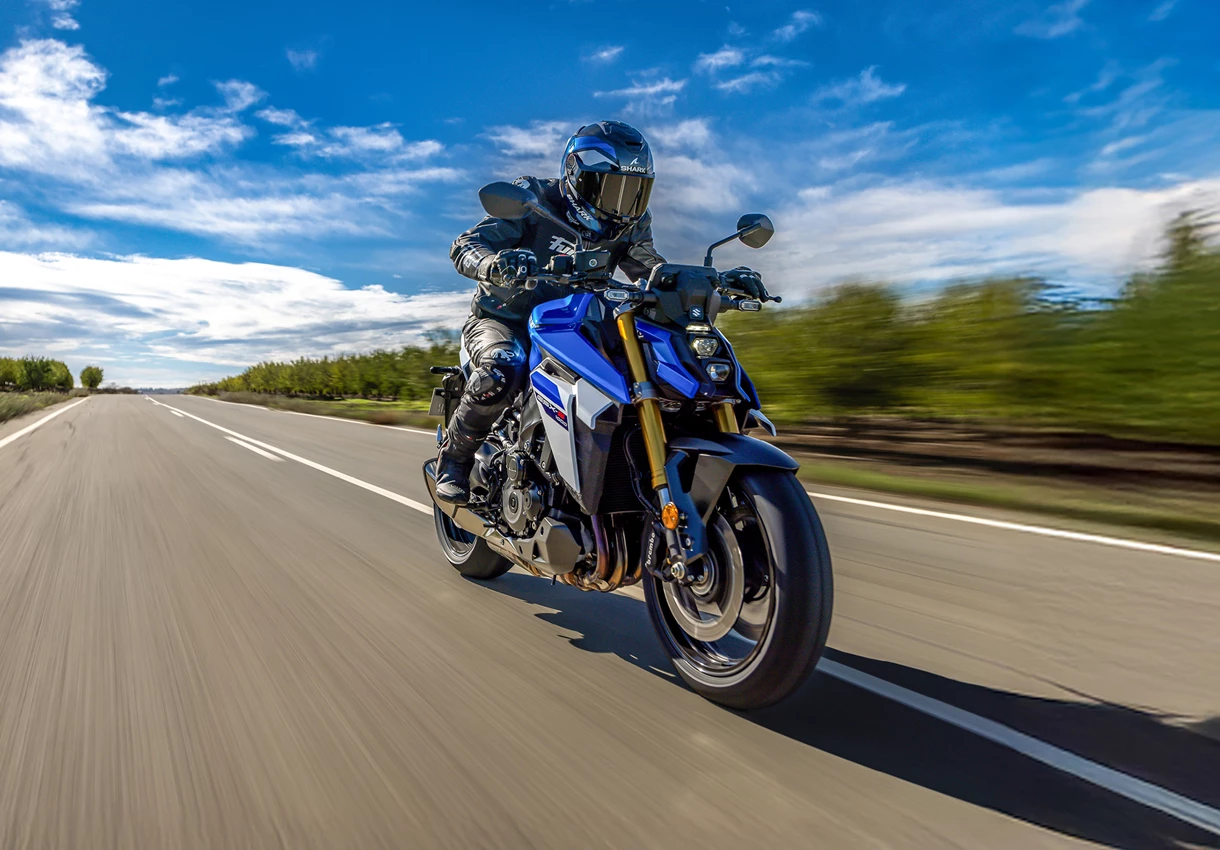 Suzuki GSX-S1000 cruising along a country road.