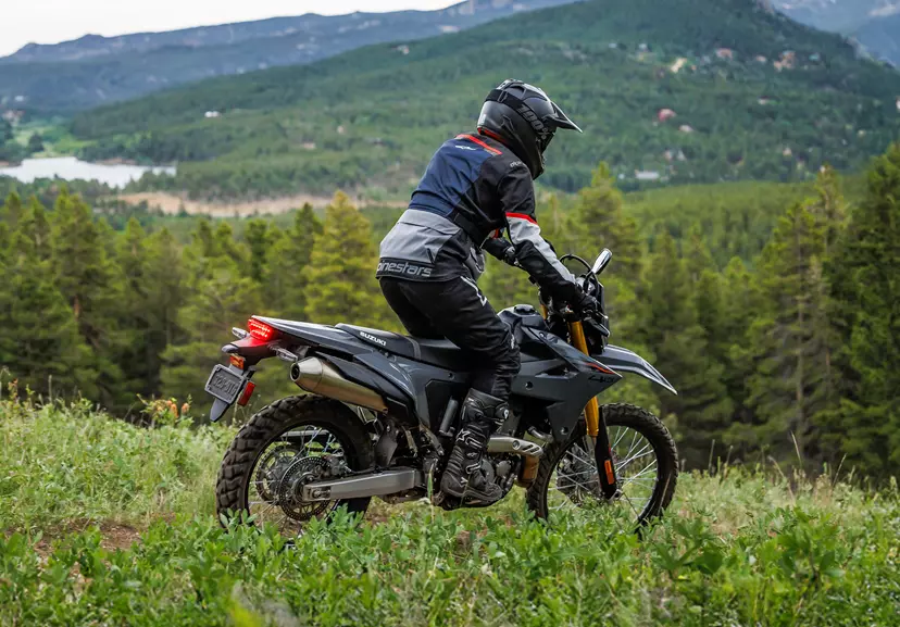 Suzuki DR-Z4S on a green lane heading down a hill