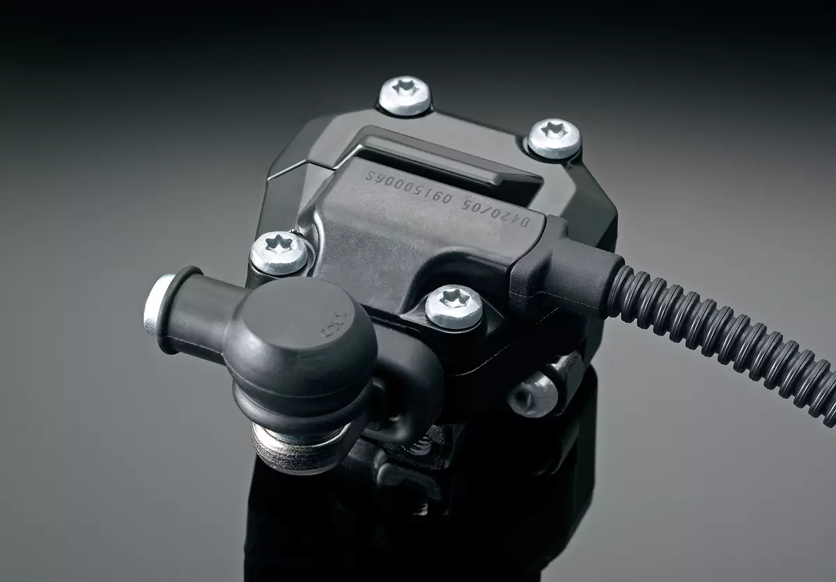 Suzuki GSX-S1000 bif-directional quickshifter unit close up with a grey studio background