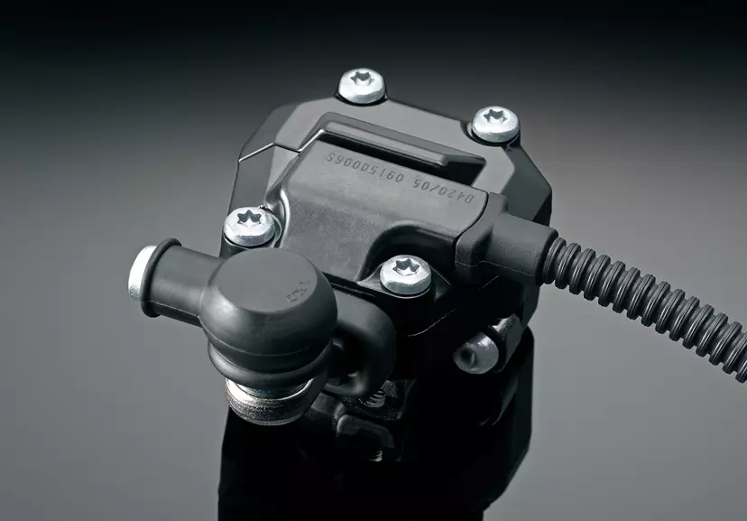 Suzuki GSX-S1000 bif-directional quickshifter unit close up with a grey studio background